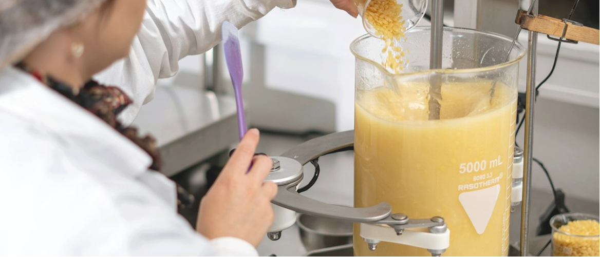 A COCOJOJO formulator blending botanical ingredients in the laboratory